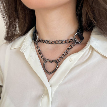 Black leather choker with dark nickel hardware and heart pendant, side angle