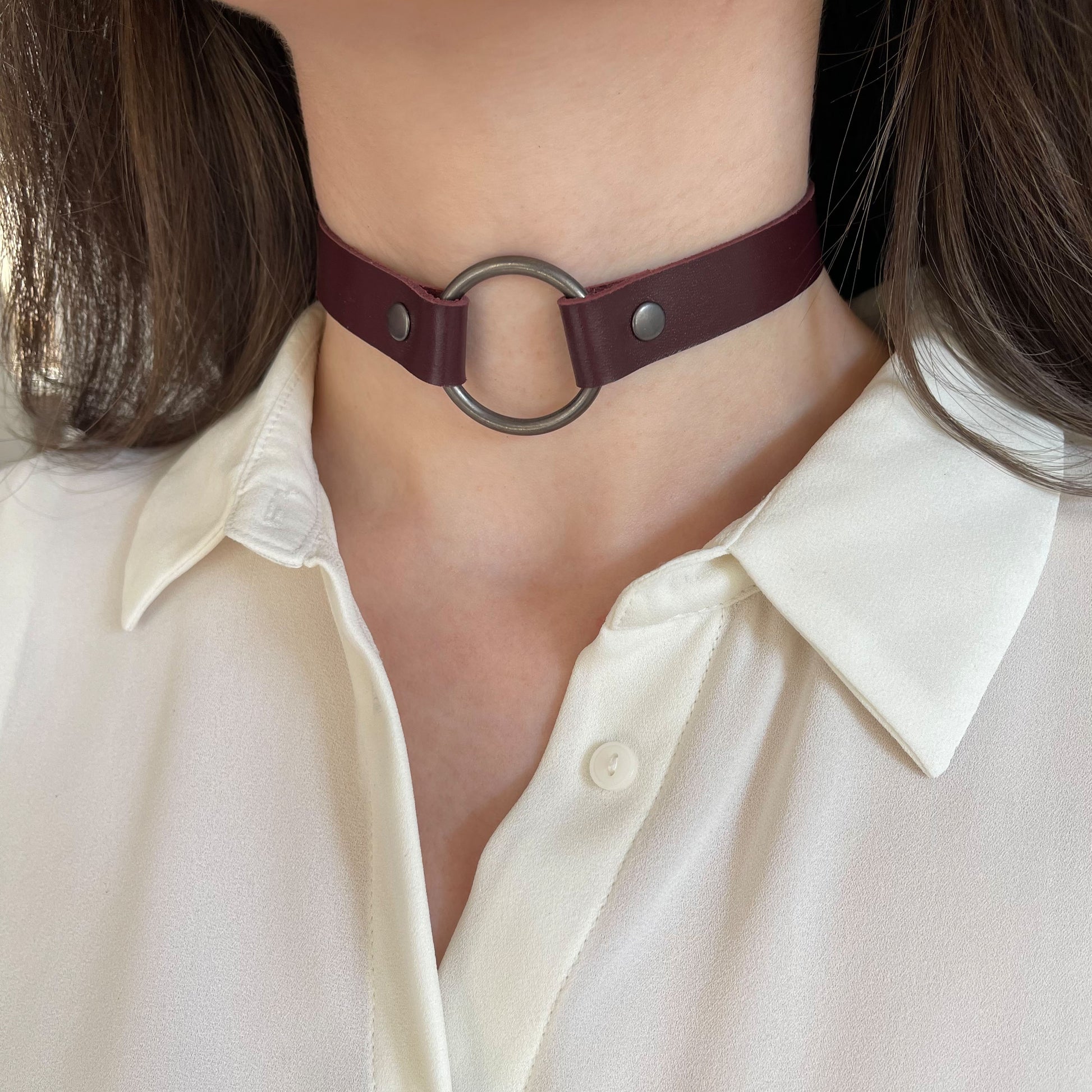 Marsala leather choker with black O-ring – angled front view on model wearing white blouse