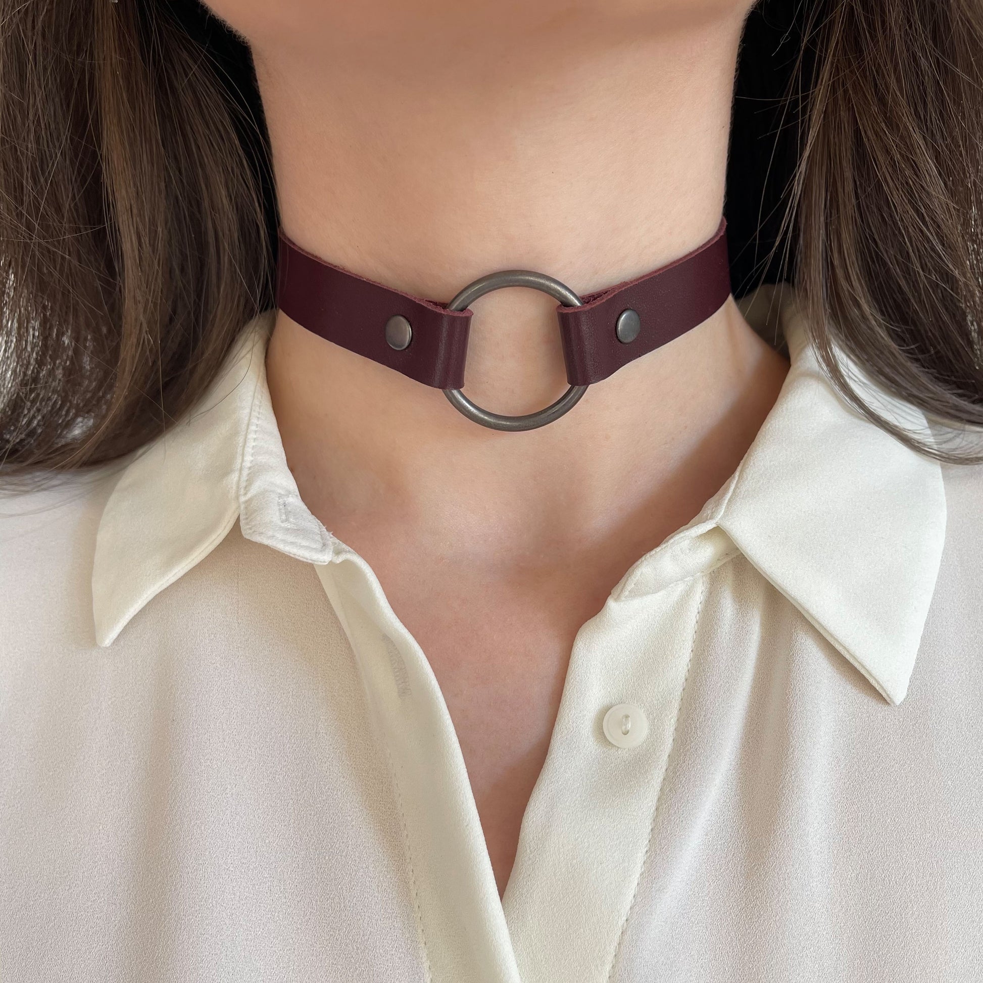 Marsala leather choker with large black O-ring – front view on model in white blouse.