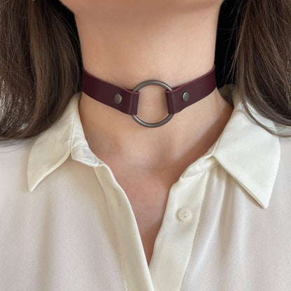 Marsala leather choker with large black O-ring – front view on model in white blouse.