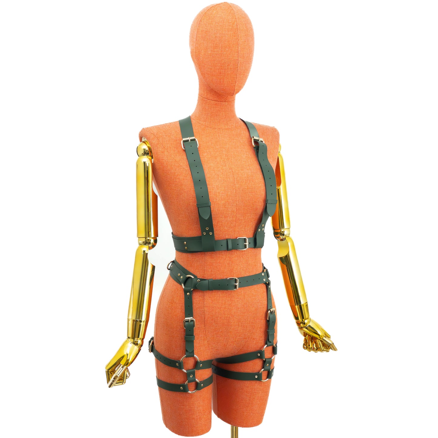 Front view of a green leather wide reversible body harness set on a mannequin, showing the side with two wide shoulder straps, an underbust belt, a separate waist belt, front garter straps, double thigh sections, gold hardware, and a clean front without a central vertical strap.