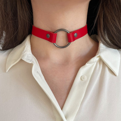 Red leather O-ring choker – centered front view on neck with white blouse.