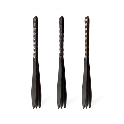 Three black leather bdsm paddles with hardware in silver, gold and dark nickel colors.