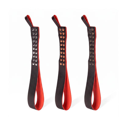 Three leather Loop Core BDSM paddle  red and black coloring and silver, gold and dark nickel hardware.