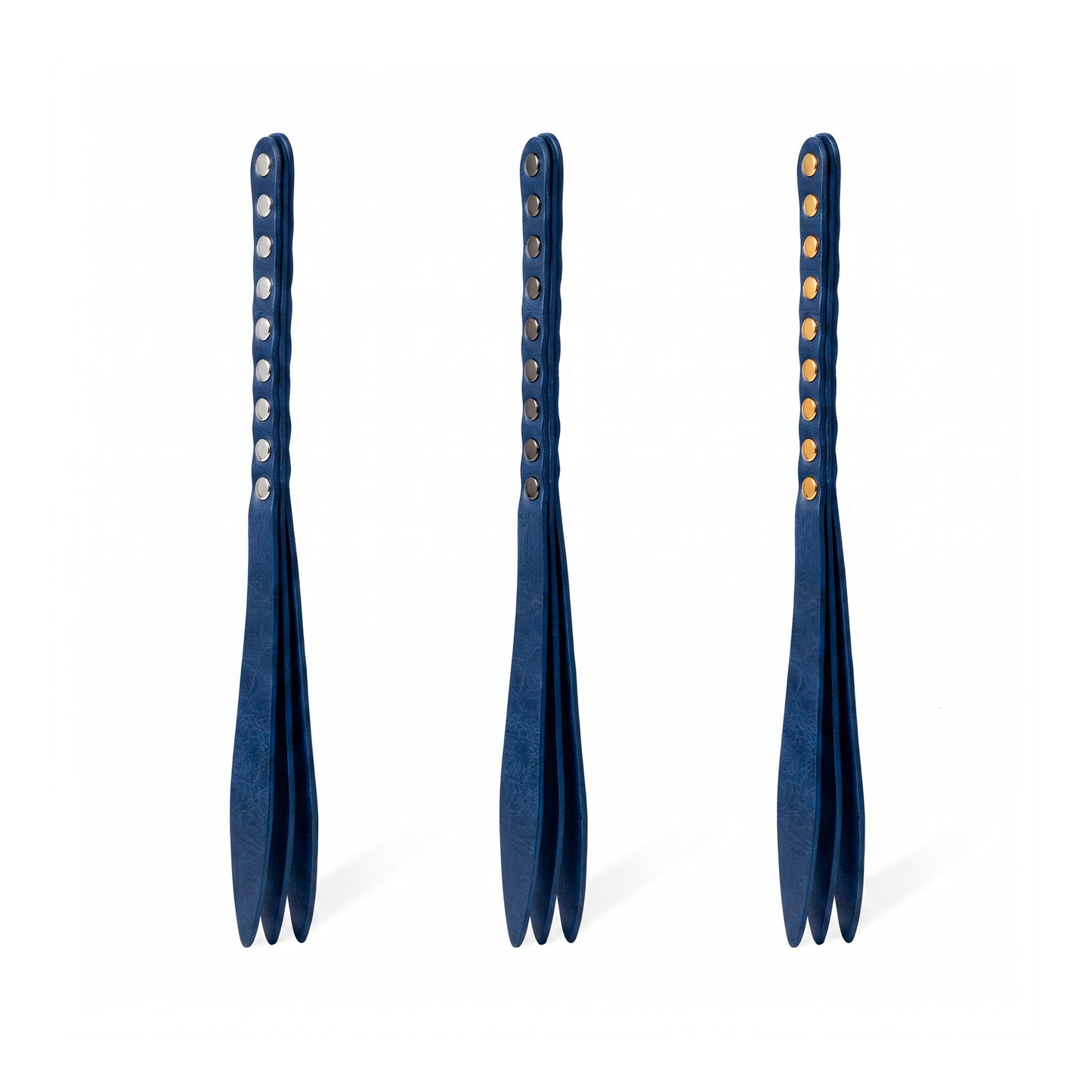 Three blue leather bdsm paddles with hardware in silver, gold and dark nickel colors.