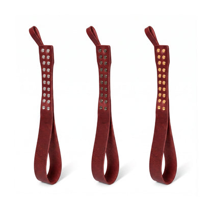 Three leather Loop Core BDSM paddle  marsala coloring and silver, gold and dark nickel hardware.