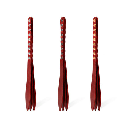 Three red leather bdsm paddles with hardware in silver, gold and dark nickel colors.
